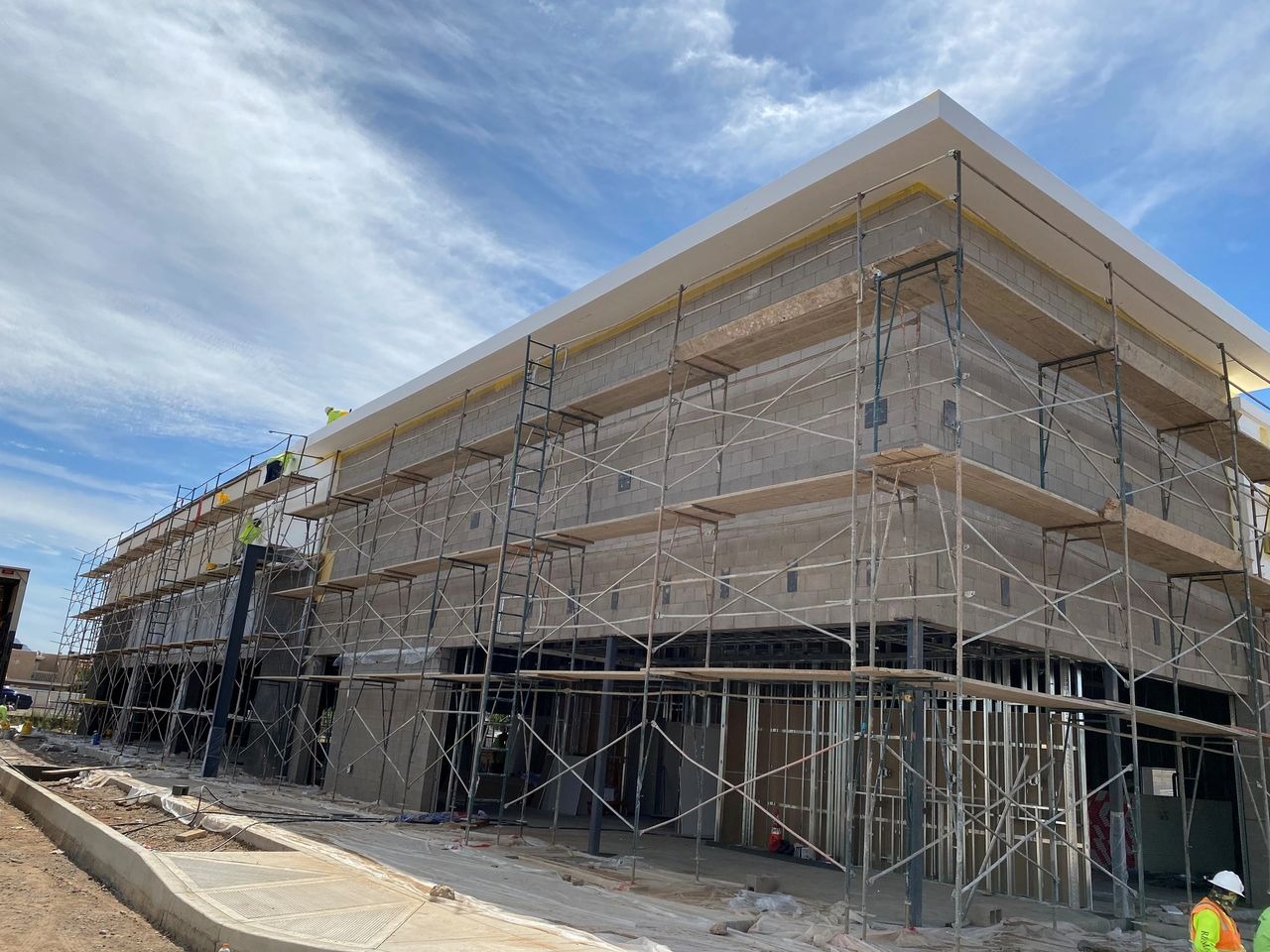 Construction site with scaffolding and workers.