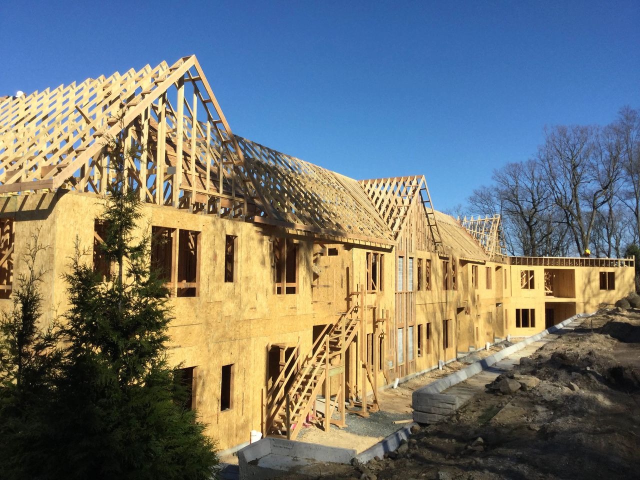 Wooden frame construction under blue sky