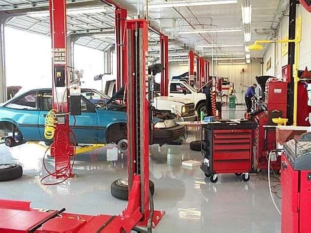 Busy auto repair shop with multiple vehicles.