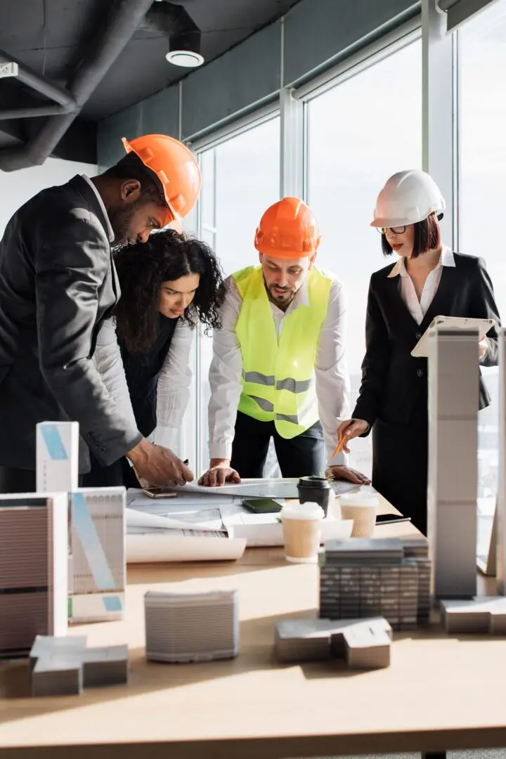 Team reviewing architectural plans in office setting.