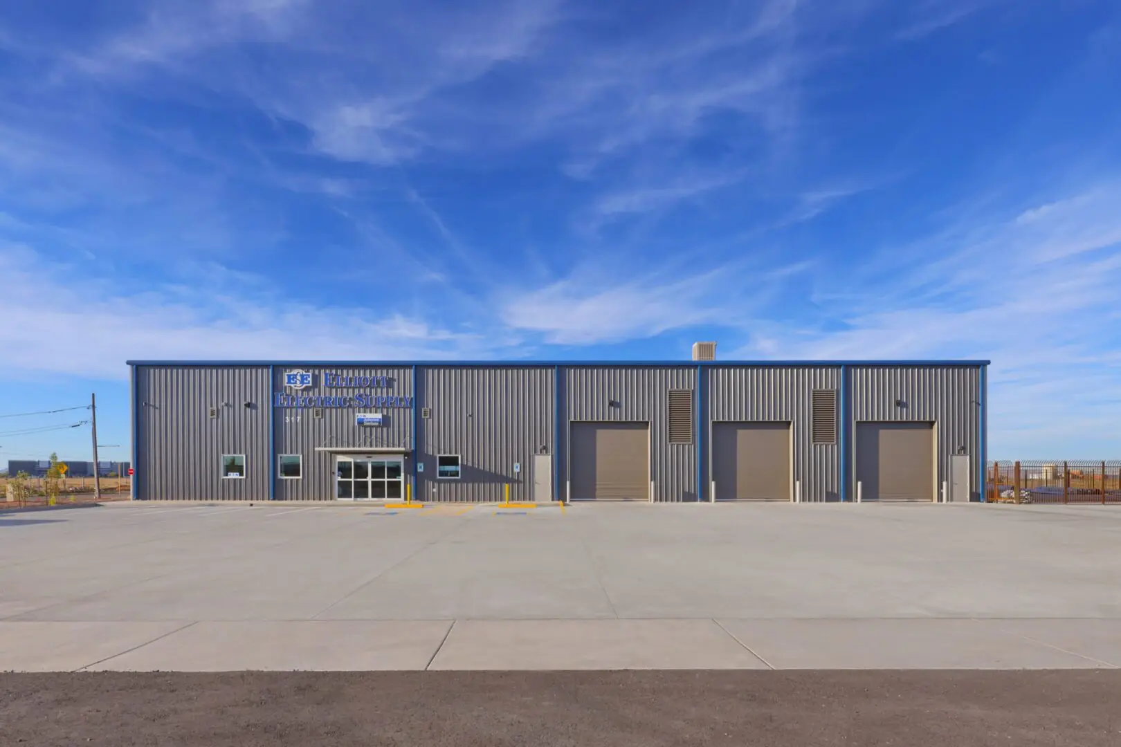 Modern electric supply building with loading docks.